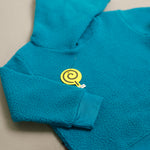 Load image into Gallery viewer, Turquoise Sherpa Tracksuit hoodie sleeve cuff close-up

