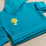 Load image into Gallery viewer, Turquoise Sherpa Tracksuit hoodie rib hem close-up
